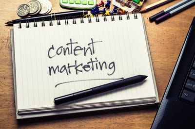 Content marketing written on note pad