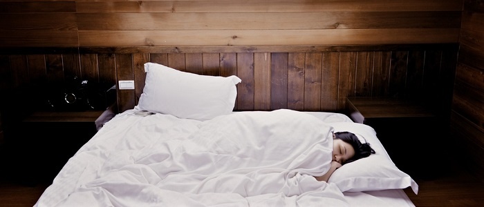 Lady relaxing taking a nap in bed 