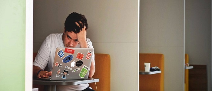 stressed guy using laptop
