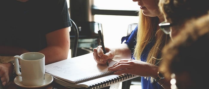 employees at a desk discussing their marketing strategy